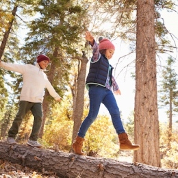 Two siblings playing i the woods