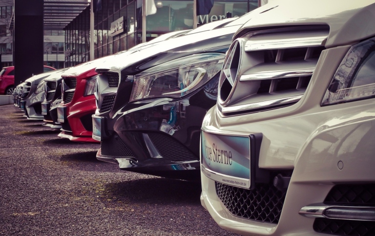 A line of cars at a car dealership