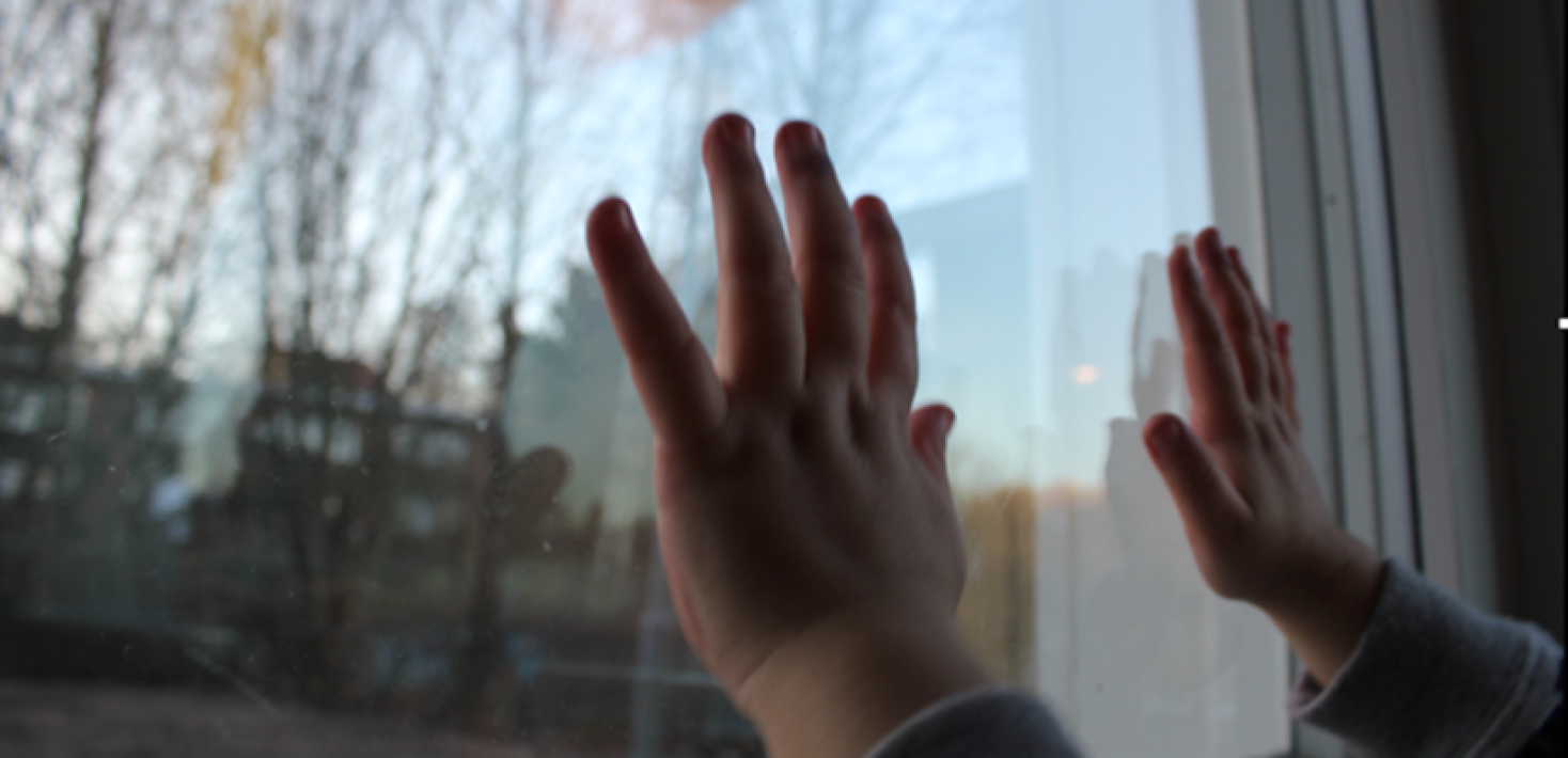 Hands against window.