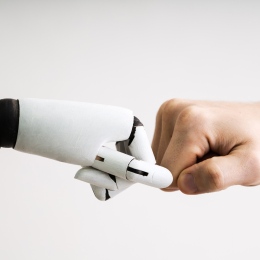 Genre photo: Robot hand and human hand in a fistbump. Photo: Andrey Popov/Mostphotos.