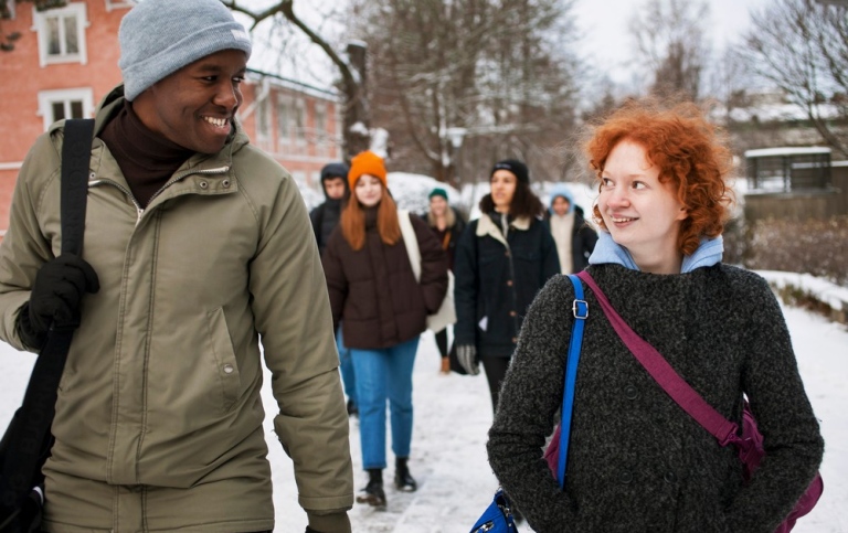 Students walking in winter landscape.