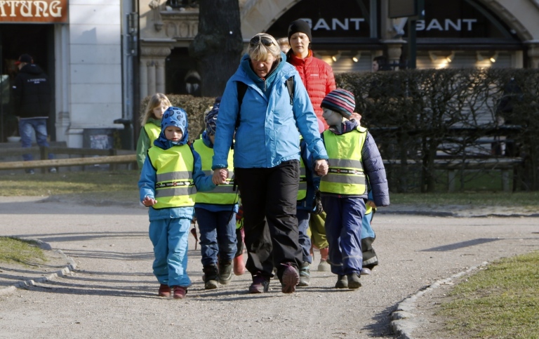 Kids in pre-school with a teacher on a walk