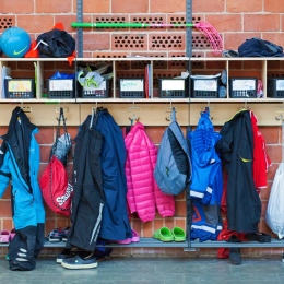 Childrens clothes hanging in the hallway in a swedish school