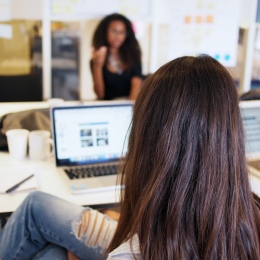 Genre photo: Three students sitting by their laptops.