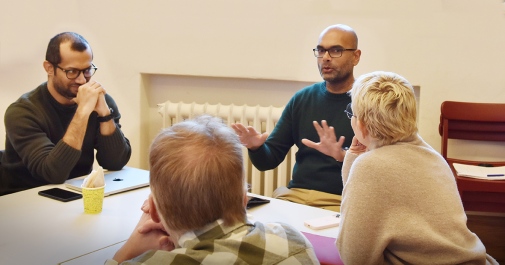 Four people sitting around a table disussing