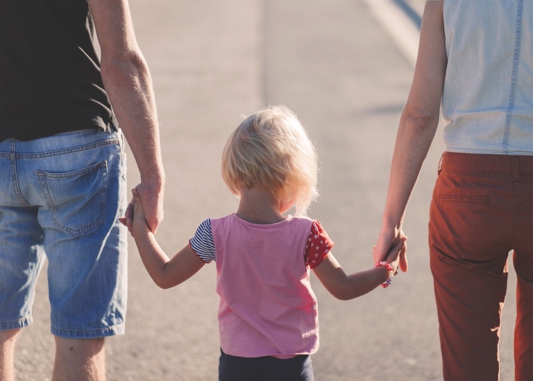 Child with parents, holding hands