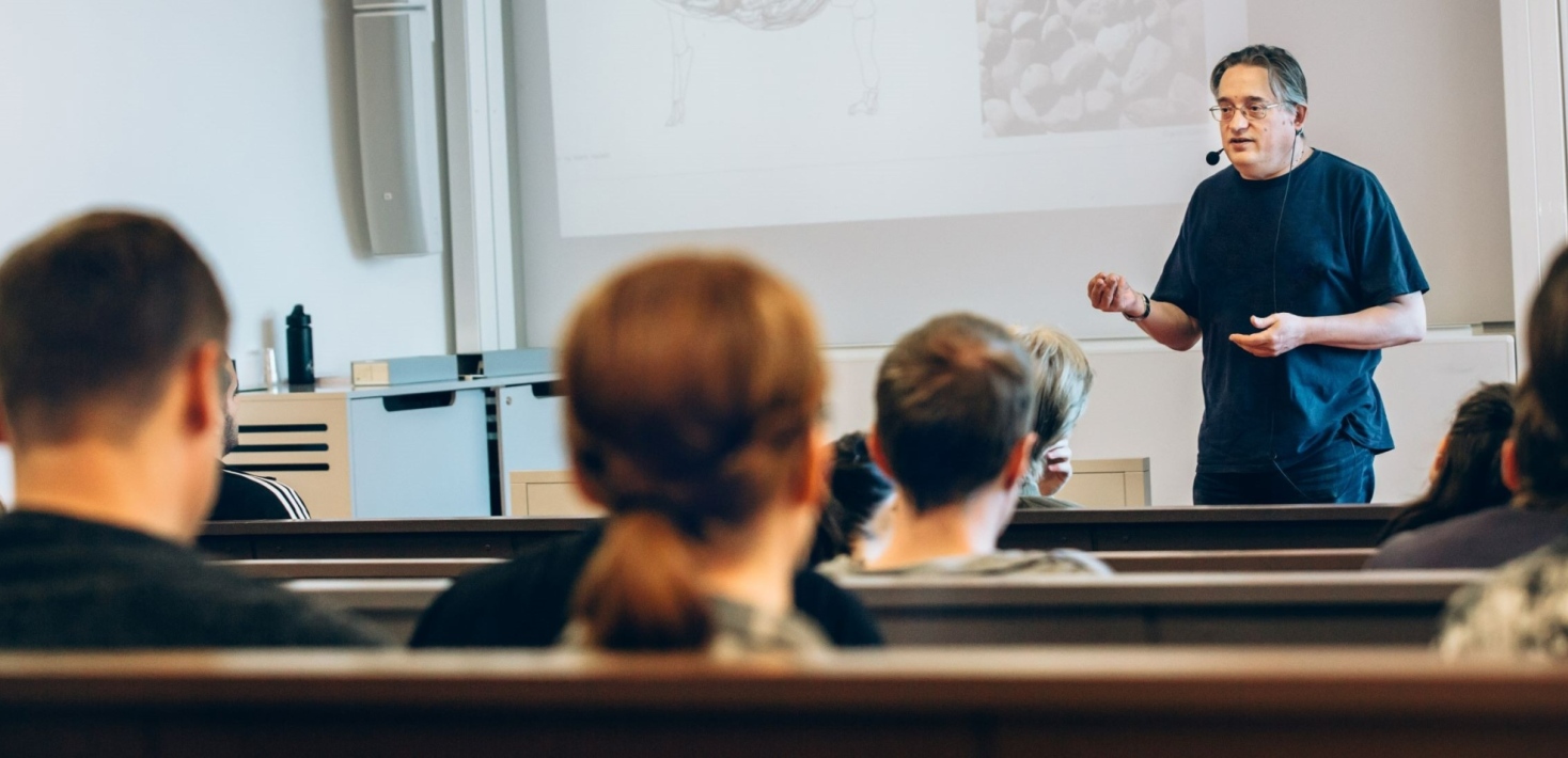 Man teaching in a lecture hall.