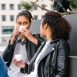 Two young women having a coffee in the city. 