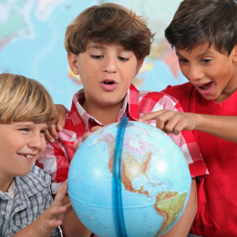 Children looking at a globe.