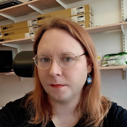 Redheaded woman with glasses and earrings