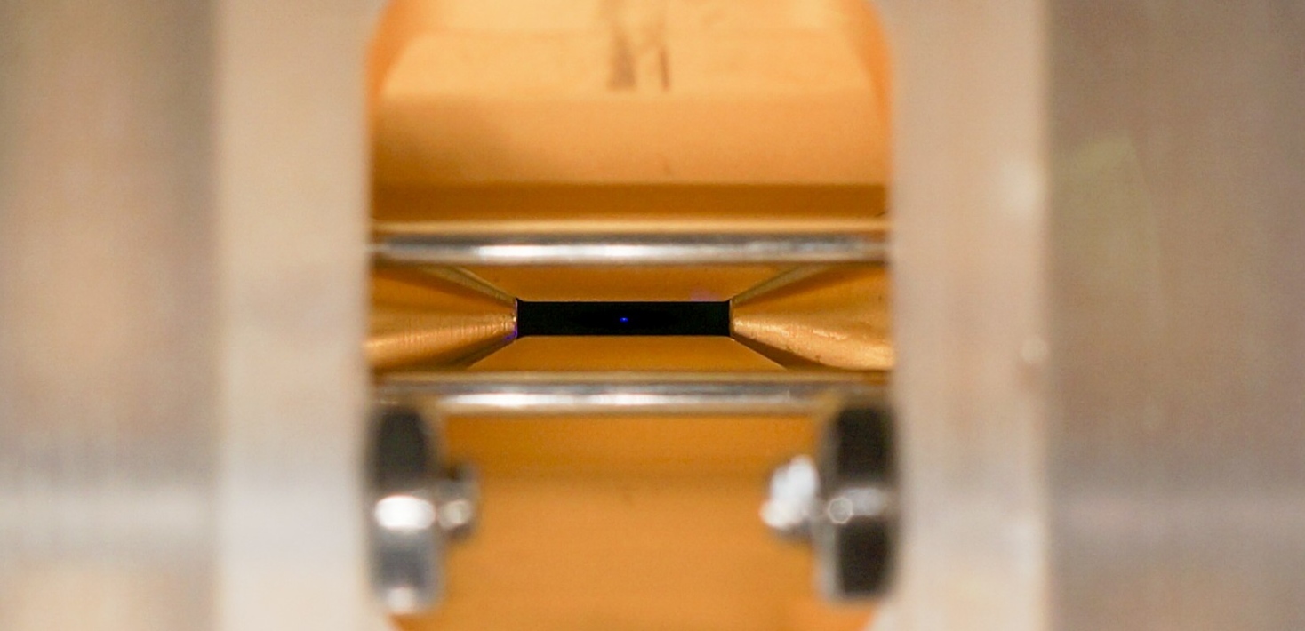 Strontium ions (blue) confined in a Paul trap 