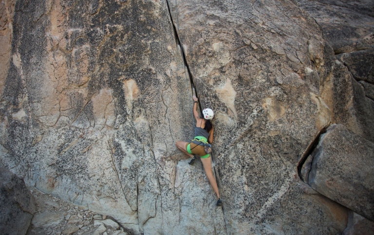 Woman climbing a mountain