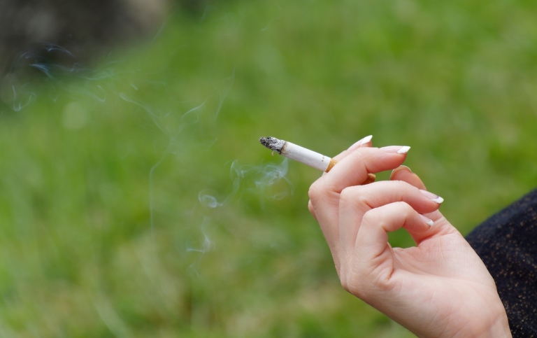 Hand holding a cigarette