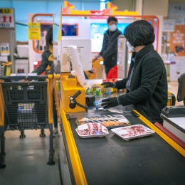 A woman standing at a cash register in a store