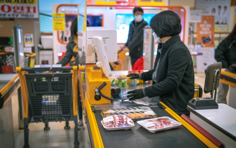 A woman standing at a cash register in a store