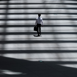 Man with a bag crosses a street