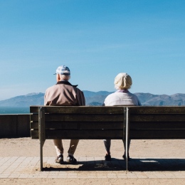 Old man and woman sitting on a bench