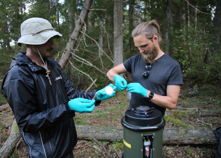 Team members taking care of filters from air particle sampling.