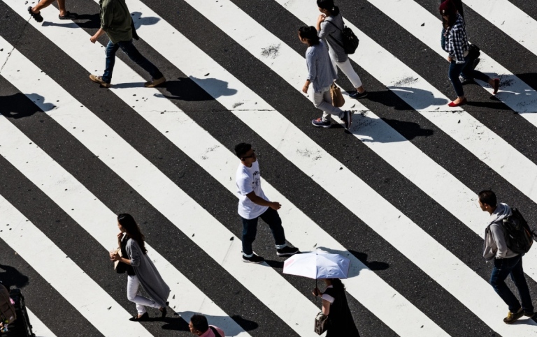 Crowd walking across a street