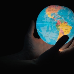 Hands holding a globe