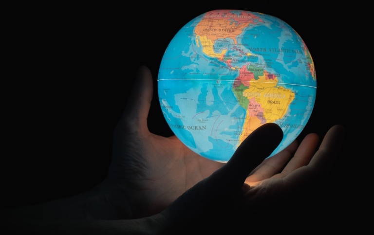 Hands holding a globe
