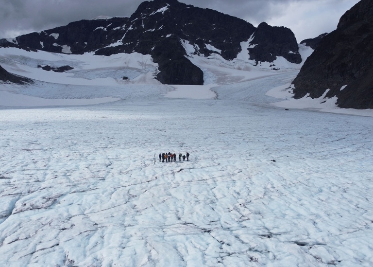 Drone photograph of the excursion team on Storglaciären, with Kebnekaise south peak visible in the b