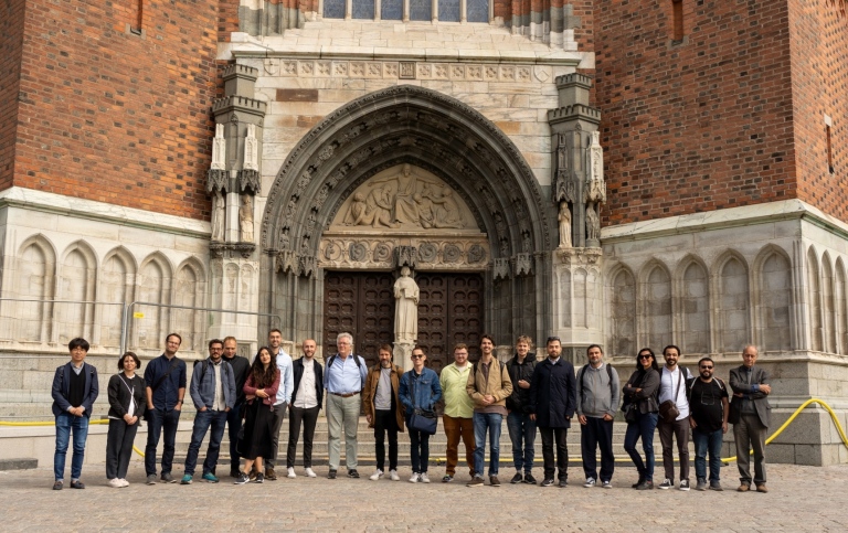 twenty people lined up in front of the entrance to the Cathedral in Uppsala 