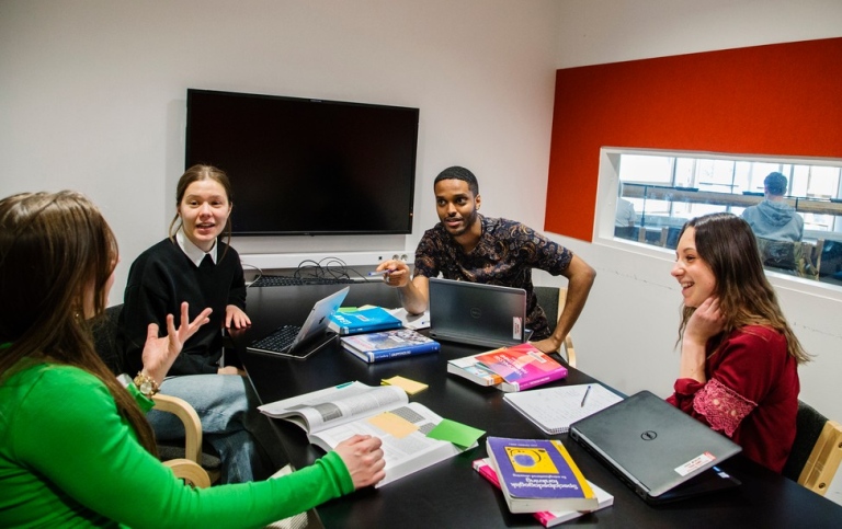 Group of students sitting talking in a group room. Photo: Lena Katarina Johansson