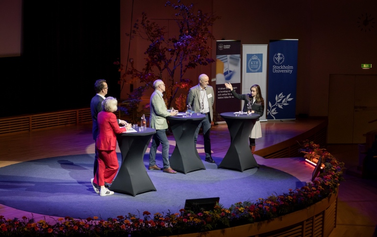 Three professors from KI, SU and KTH on stage.