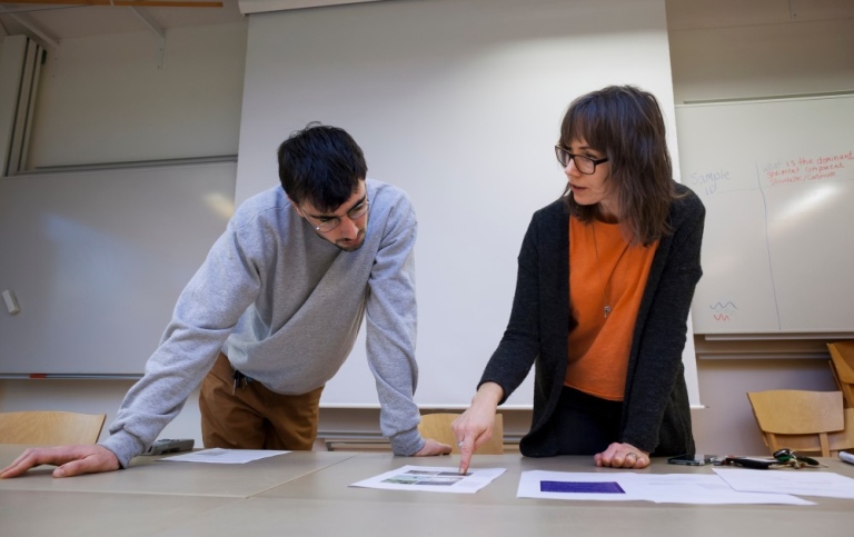 A teacher explains something to a student.