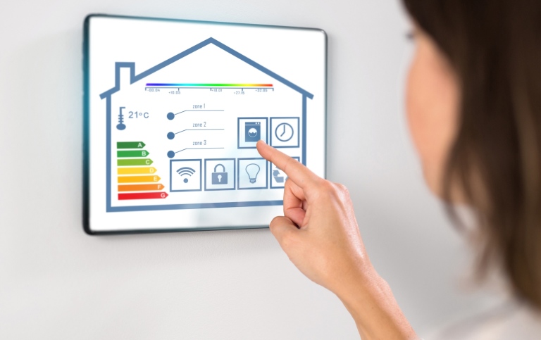 A woman touching a smart screen representing her smart home.