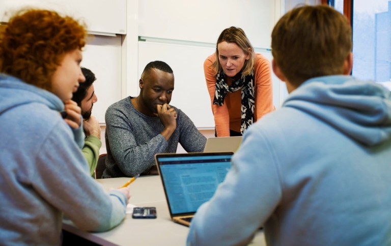 Students and teacher in a classroom.