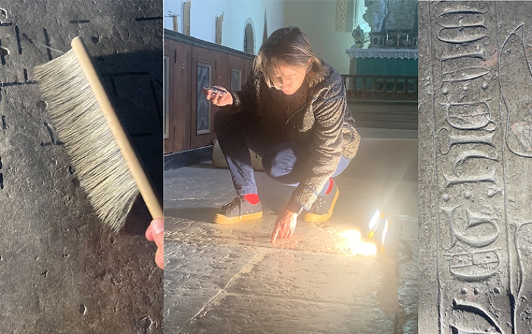 Sofia Pereswetoff-Morath sitter på huk och undersöker inskrifter på golvet i Lau kyrka.