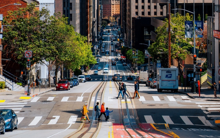 San Francisco street with buildings, cars and pedestrians.