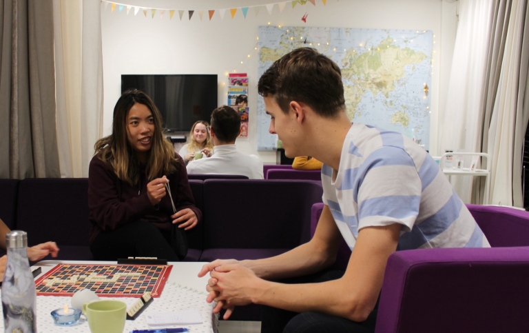 Two students talking over a cup of tea