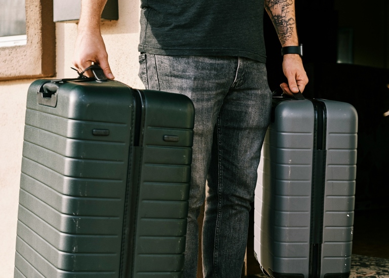 A man holding two suitcases.
