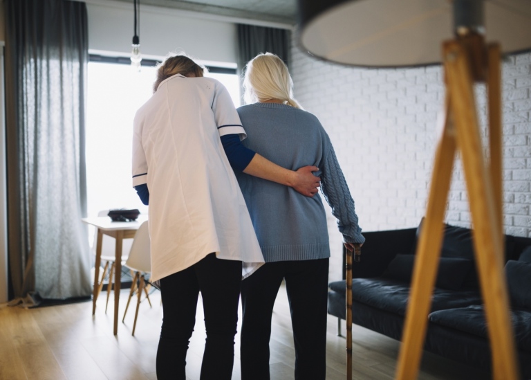 Woman walking with nurse old age home