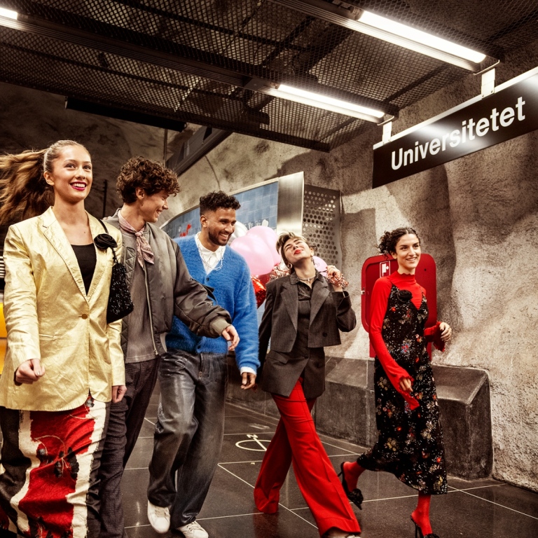 Students on an underground train platform.