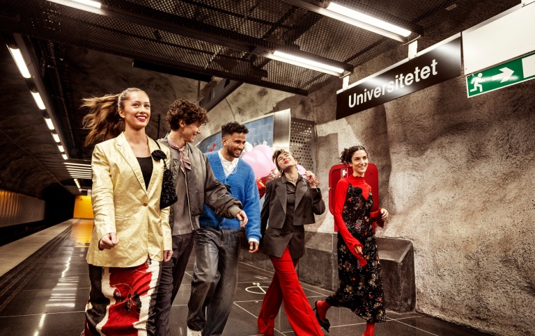 Students on an underground train platform.