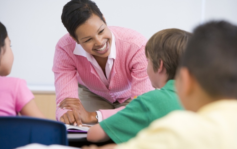 Teacher talking to young learners in the classroom