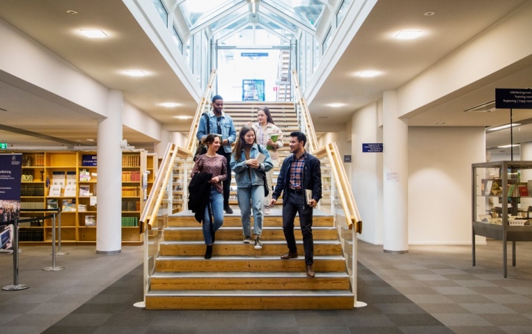 Studenter i en trappa i biblioteket.