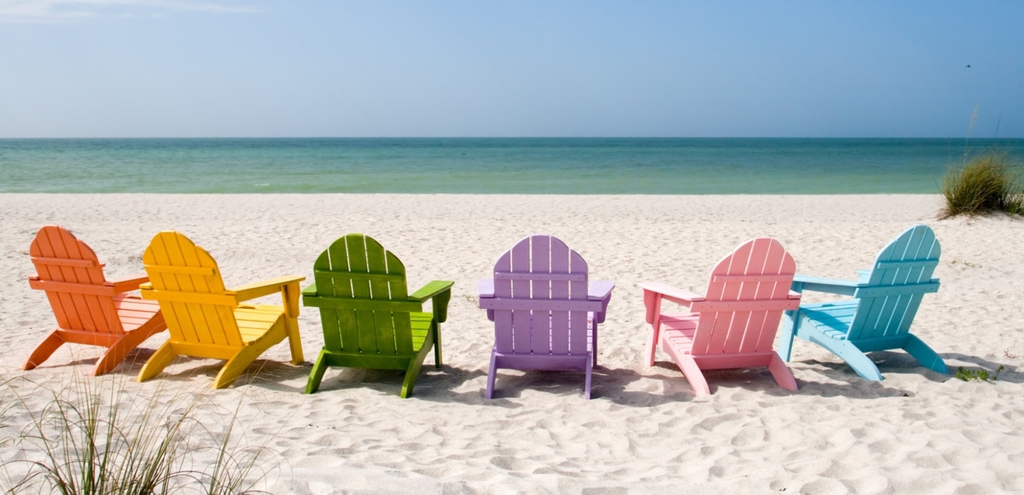 Colourful sun chairs on a beach. 