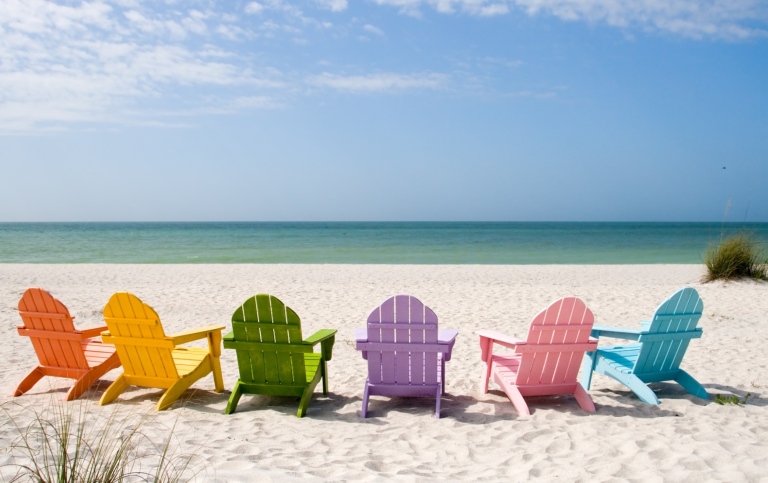 Colourful sun chairs on a beach. 