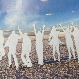 White silouettes of 7 excited people on the beach.