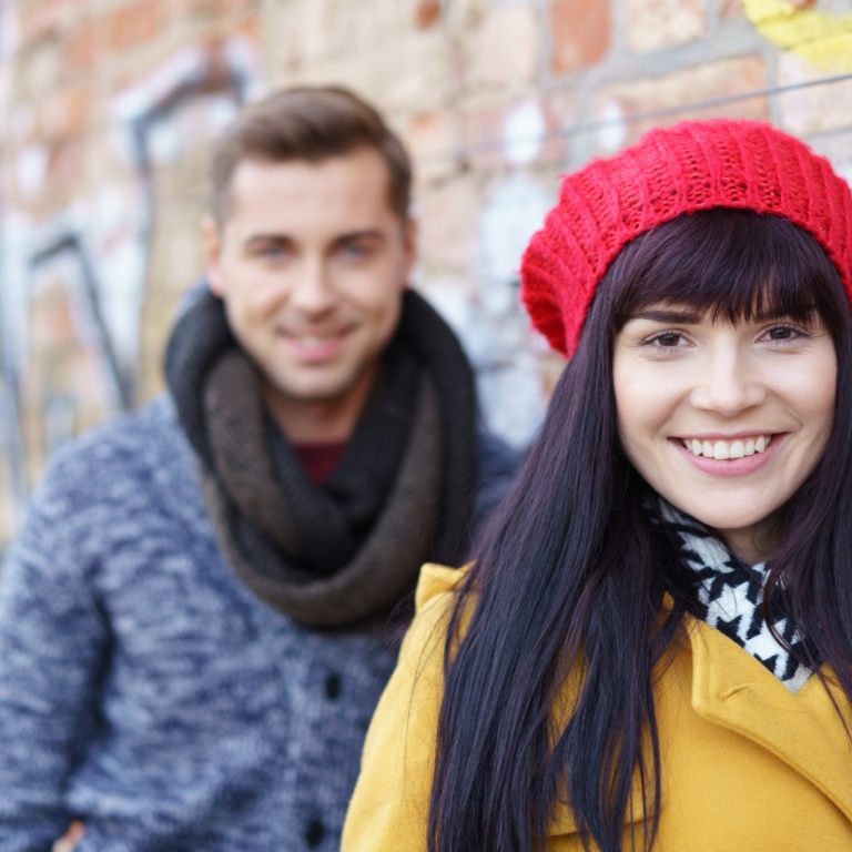 happy woman and man outside in winter