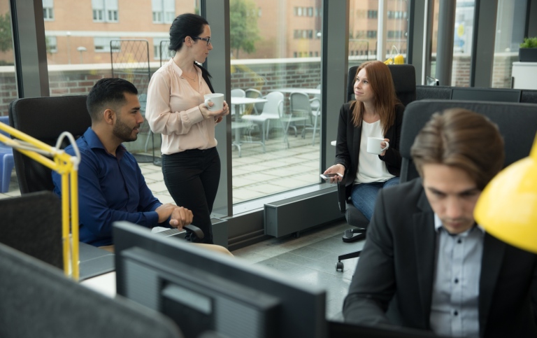 Colleagues chatting in an office.