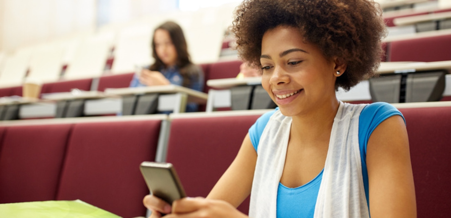 Sudents in lecture room using smartphones