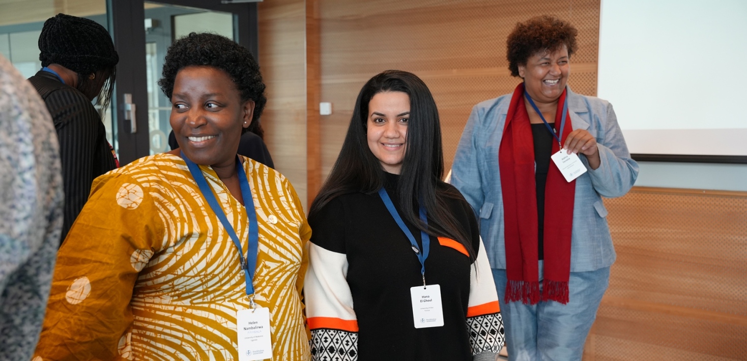 Three women in a row at a meeting