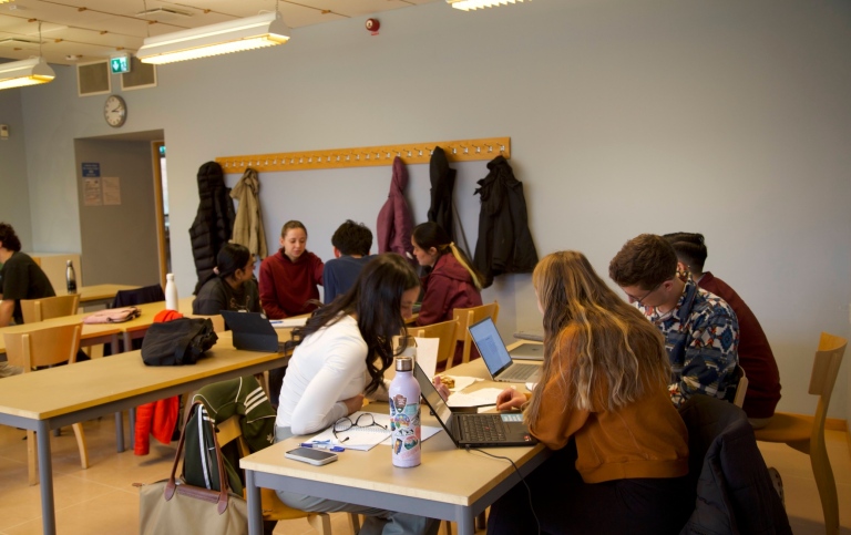 students sitting in tables talking
