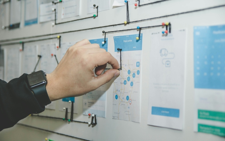 A person planning for digital transformation, mapping the organisation's needs on a wall.